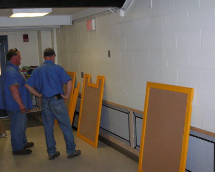 Maintenance crew install bulletin boards